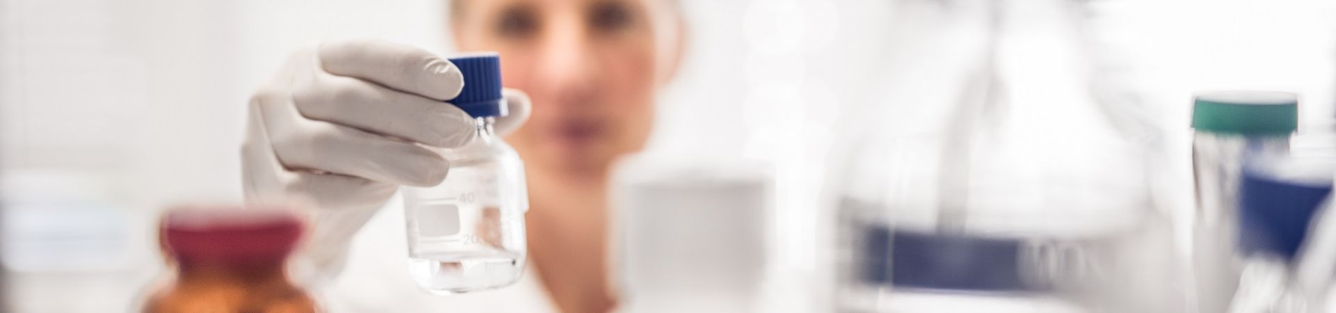 Researcher places a sample bottle on a shelf