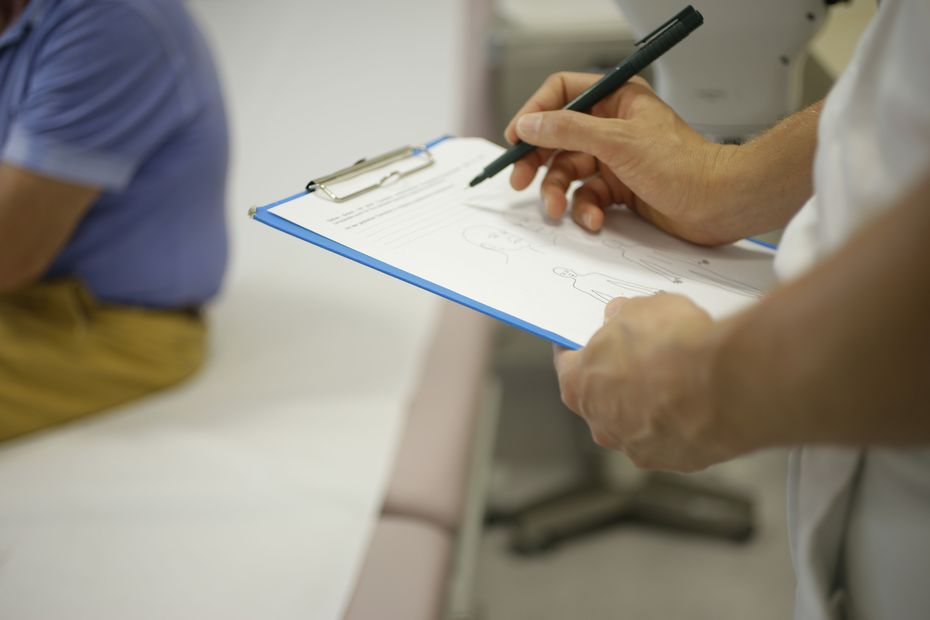 Doctor making notices during a study visit