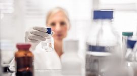 Researcher places a sample on a shelf in the laboratory