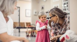 Girl laughs at her mother and a doctor