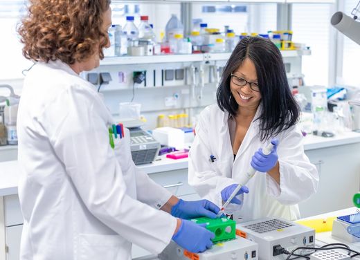 Two female EB researchers working in a lab.
